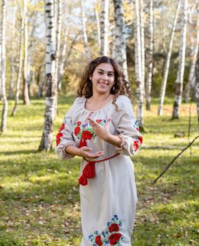 Indigenous people. beautiful woman in national ukrainian national traditional costume clothes dancing in forest