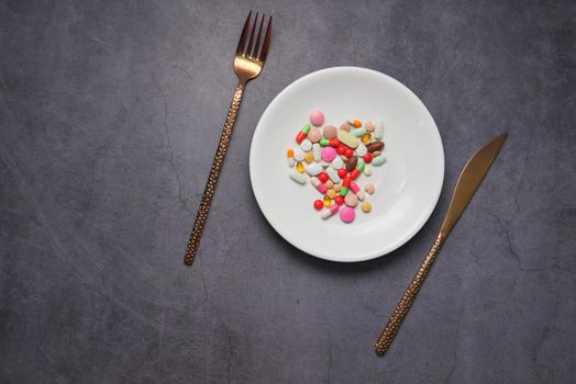 close up of colorful pills on plate .