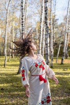 Indigenous people. beautiful woman in national ukrainian national traditional costume clothes dancing in forest