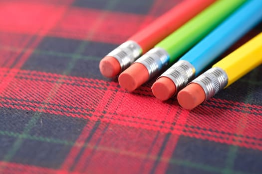 Close up of colorful pencils on notepad .