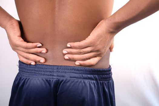 young man in blue shirt suffering back pain