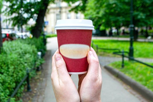 Coffee Business Concept-Female barista making coffee and serving a paper cup of hot coffee in street. High quality photo