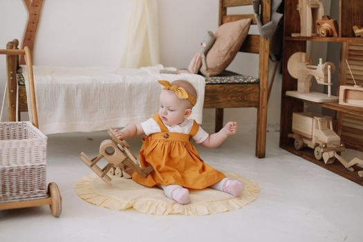 Adorable happy baby girl playing in a sunny room. Portrait of a happy child at home.