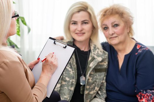 female psychologist with clipboard in therapy.