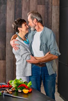 aged couple in the kitchen preparing food