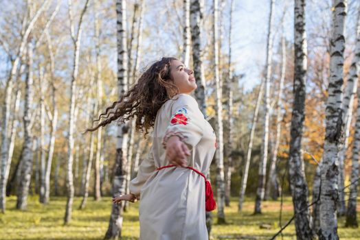 Indigenous people. beautiful woman in national ukrainian national traditional costume clothes dancing in forest