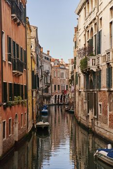 Venice, Italy - 10.12.2021: Traditional canal street with gondolas and boats in Venice, Italy. High quality photo