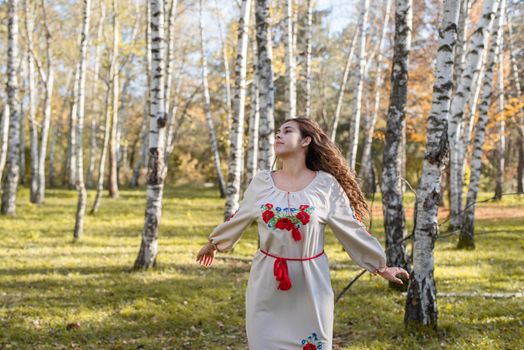 Indigenous people. beautiful woman in national ukrainian national traditional costume clothes dancing in forest