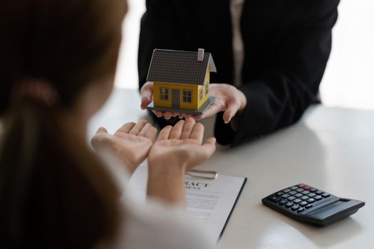 Home and real estate trading business. Real estate agent giving keys to house woman owner