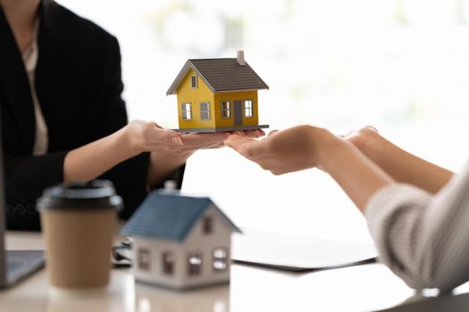 Home and real estate trading business. Real estate agent giving keys to house woman owner