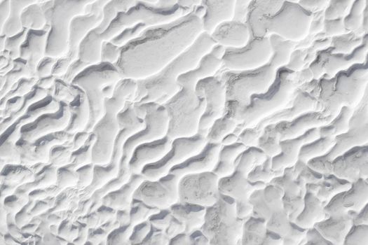 White textured background of Pamukkale calcium travertine in Turkey, abstract pattern of close-up