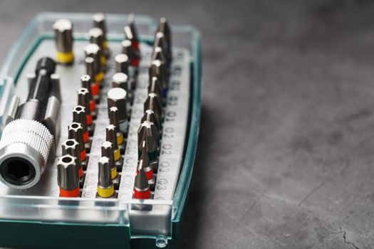 A set of metal bits for screwdrivers in a box. Hexagon head of different sizes