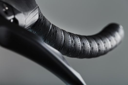 Handlebar winding of a road bike close-up on a gray background