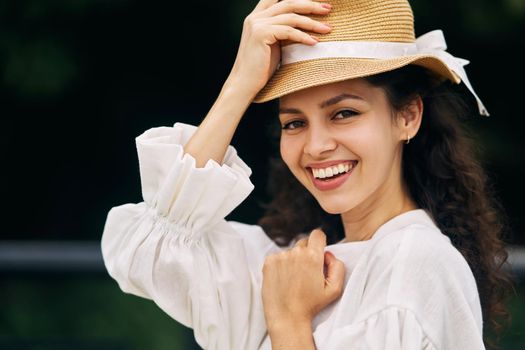 Young beautiful girl in a hat in a summer park. High quality photo