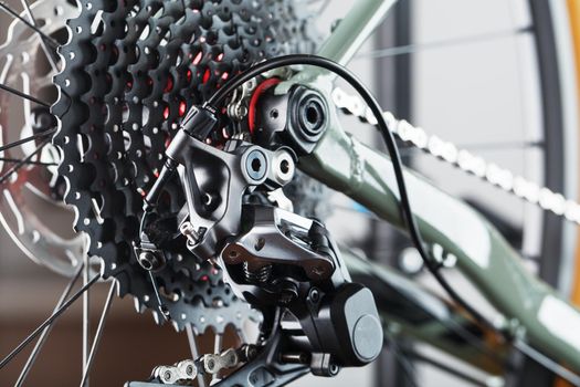 Rear bicycle cassette speeds with a wide range and chain close-up, accessories for repair and tuning of the bike