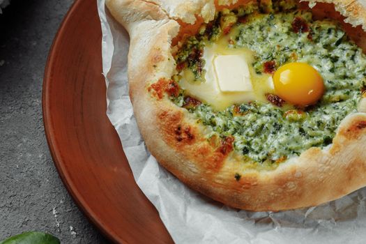 Some khachapuri traditional Georgian homemade cheese and spinach pies on the plate.