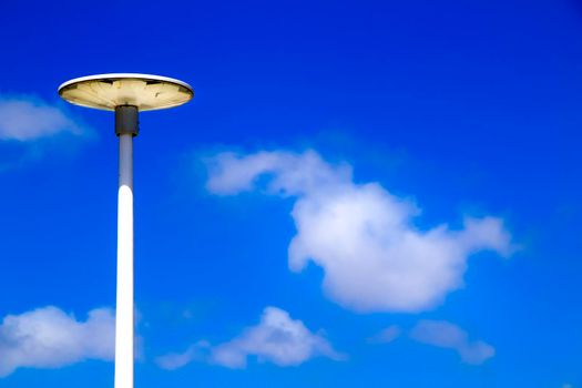 White lamppost in the morning under blue sky in Spain