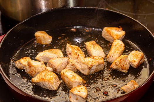 turkey fillet pieces frying on nonstick pan.