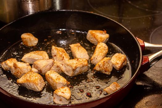 turkey fillet pieces frying on nonstick pan.