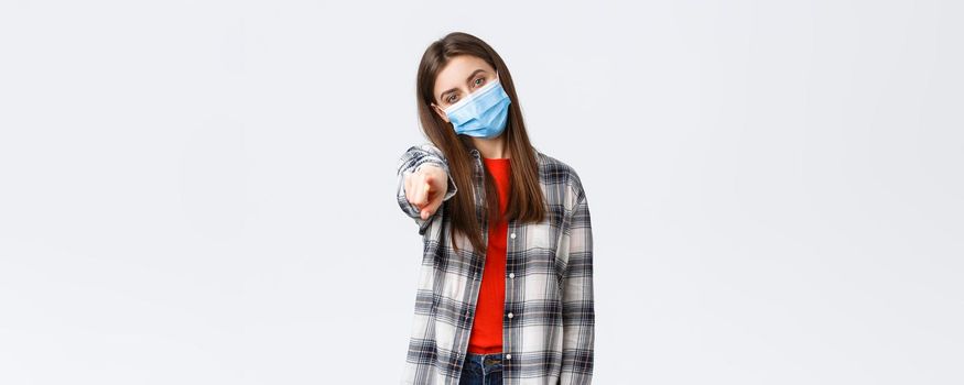 Coronavirus outbreak, leisure on quarantine, social distancing and emotions concept. Young determined girl making choice, pointing finger at camera, need you, wear medical mask. ask join team.