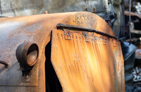 Broken and burned cars in the parking lot, accident or deliberate vandalism. Burnt car. Consequences of a car accident. Damaged by arson. Dump of civilian vehicles shot by Russian troops in Ukraine