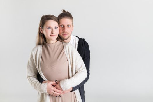 Portrait of a young european couple in love on a white background.