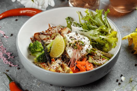 Healthy bowl - quinoa salad with tuna, broccoli, avocado on wooden rustic table. top view.