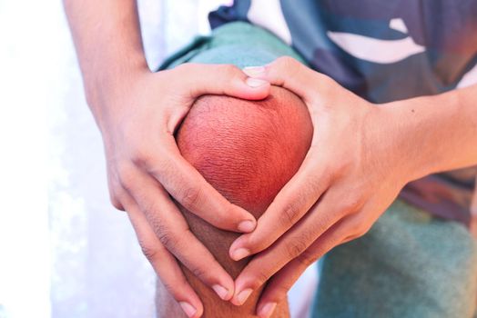 Close up on man suffering knee joint pain.