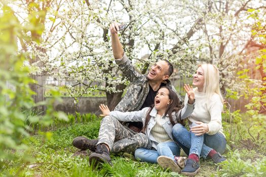 Happy soldier with family in park