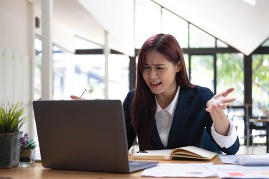 Asian woman working laptop. Business woman busy working on laptop computer at office..