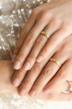 Close up of wedding rings on hands of newlyweds. Hands of the bride and groom