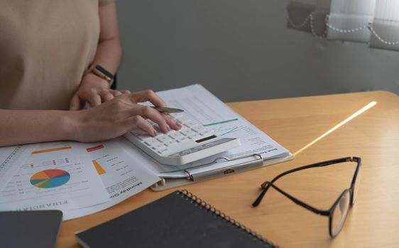 Business analysis, investment and finance concept. Business man, accountant calculate business report, marketing data, financial graph while working on laptop computer with spreadsheet on office desk.