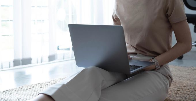 Close up image of woman hands typing on laptop computer keyboard and surfing the internet on office table, online, working, business and technology, internet network communication concept.