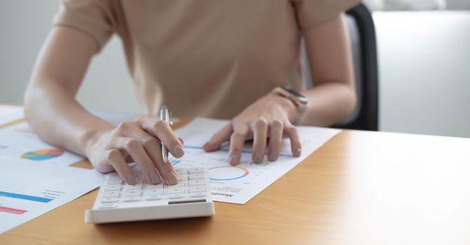 Close up businessman hand using calculator and writing make note with calculate about finance accounting.finance accounting concept.