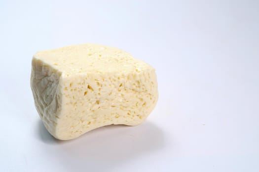 close up of fresh cheese on white background