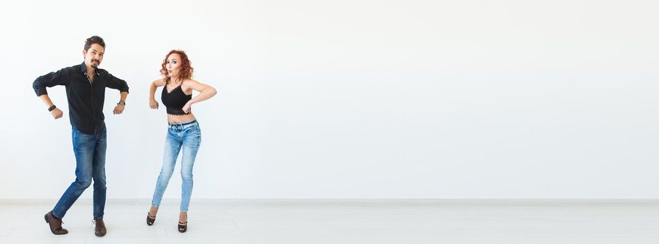 Social dance concept - Crazy dancing, cheerful couple over white background.