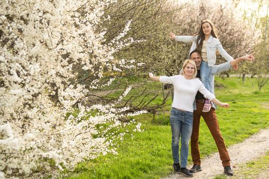 Family and child outdoors in spring nature, resting