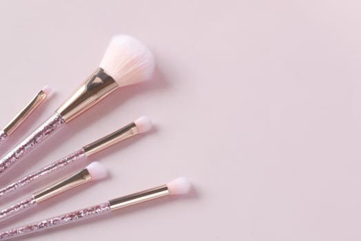 beauty brush on light pink background .
