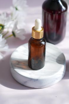 eucalyptus essential oils in a glass bottle and flower on table .