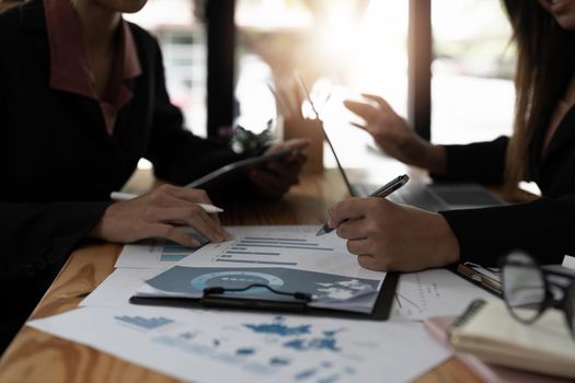 Asian business adviser meeting to analyze and discuss the situation on the financial report in the meeting room.Investment Consultant, Financial advisor and accounting concept.