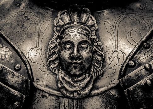 Detail Of A Face On The Breastplate On A Medieval Suit Of Knight's Armour
