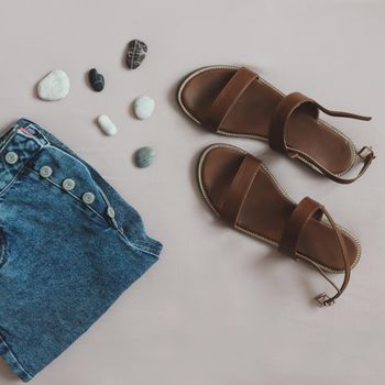 Summer fashion, vacation on sea concept. flat lay composition with sandals and denim shorts top view.