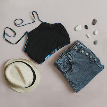 Summer fashion, vacation on sea. Swimwear, denim shorts, straw hat top view, flatlay.