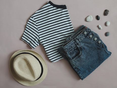 Summer fashion, vacation on sea. flat lay with top, denim shorts, straw hat top view.