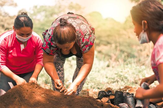 Group of Nicaraguan women planting trees in a rural area of Masaya Nicaragua