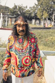 Impersonator of Jesus Christ with psychedelic clothes in a cemetery in Managua Nicaragua