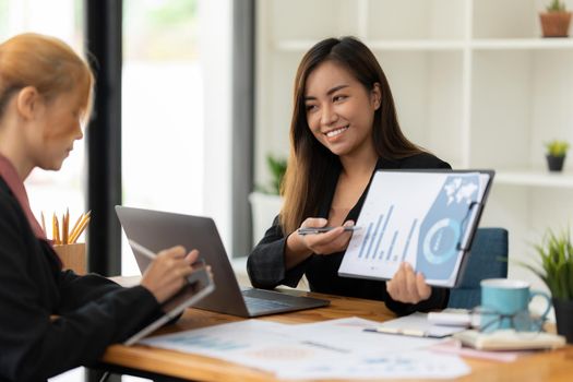 Cheerful business people discussing or brainstorming about marketing plan and financial of company. Account concept