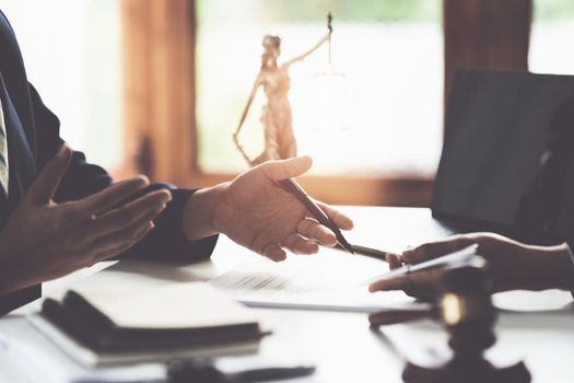 Business woman and lawyers discussing contract papers with brass scale on wooden desk in office. Law, legal services, advice, Justice concept