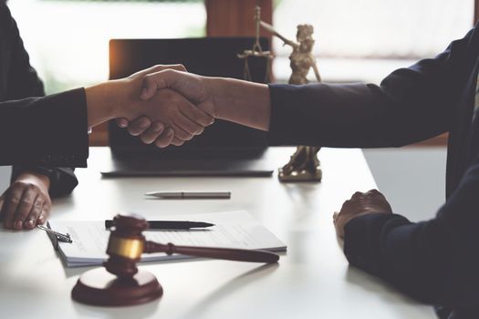 Business woman and lawyer shaking hand after discussing about agreement contract. Law, legal services, advice, Justice concept