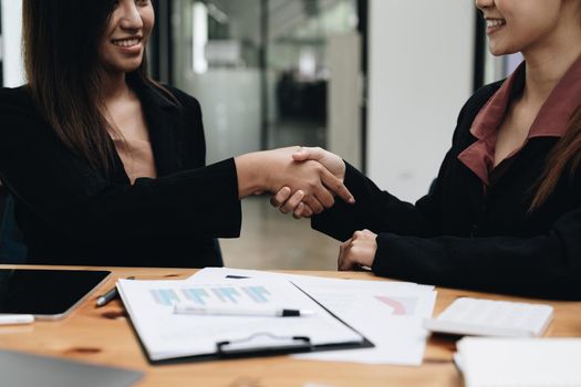 Business asian people shaking hands, finishing up meeting, business etiquette, congratulation, merger and acquisition concept.